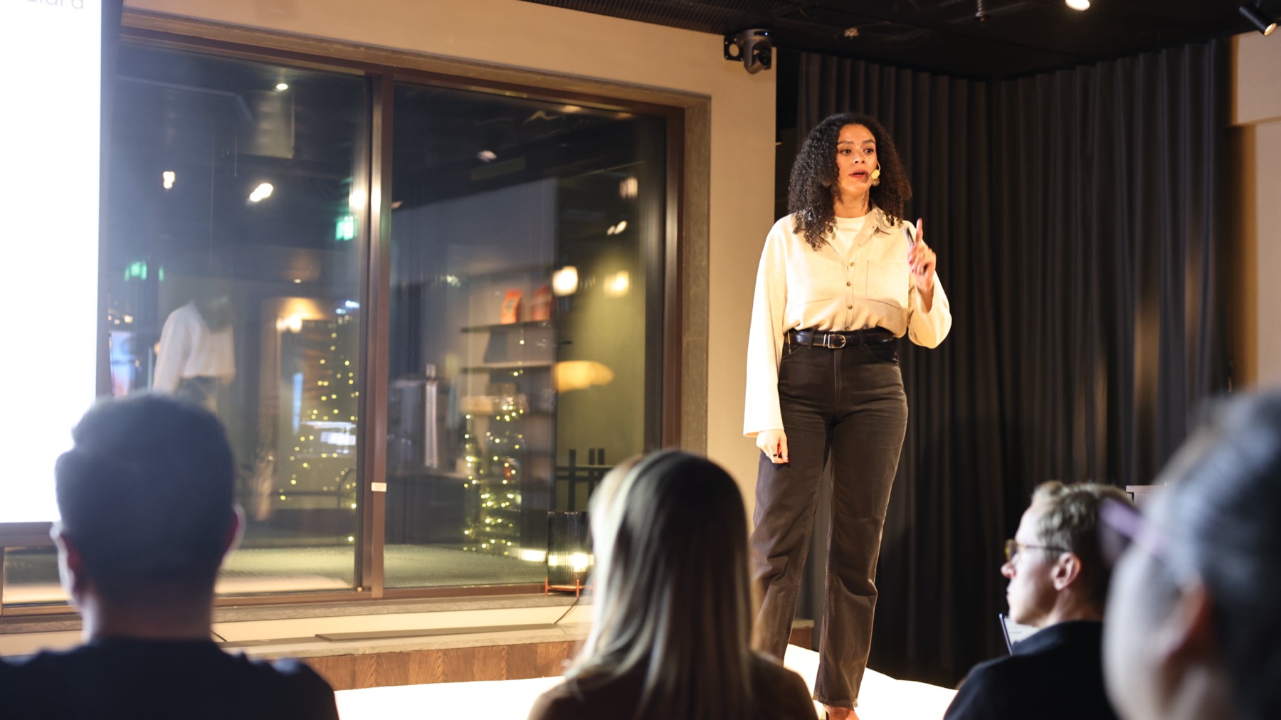 Mélanie Choko speaking on stage to an audience